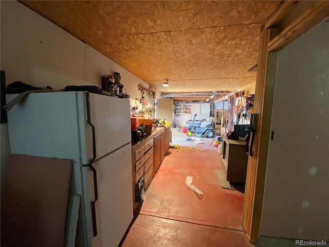 12729 Desert Dr, Sterling, CO 80751 - kitchen featuring freestanding refrigerator and concrete flooring