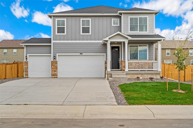 view of front of property featuring a garage and a front lawn