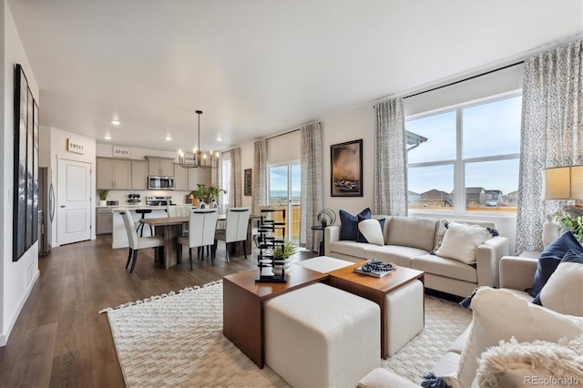 living room with hardwood / wood-style flooring and a notable chandelier