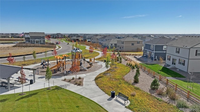 view of home's community featuring a playground and a yard