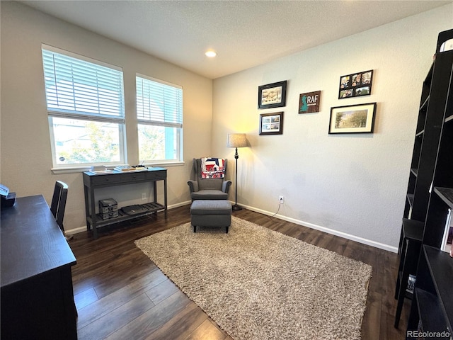 sitting room featuring a textured ceiling and dark hardwood / wood-style flooring