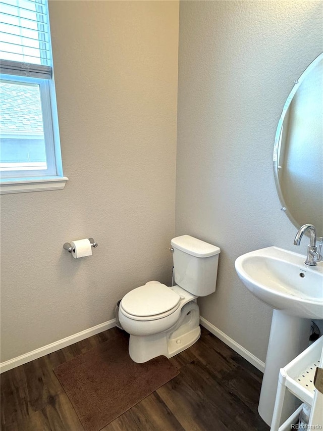 bathroom featuring hardwood / wood-style flooring, sink, and toilet