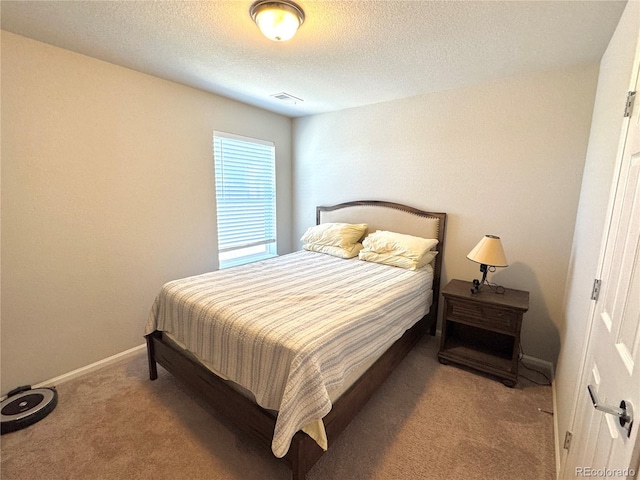 carpeted bedroom featuring a textured ceiling