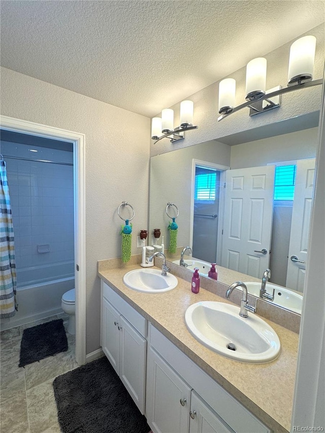 full bathroom featuring vanity, toilet, a textured ceiling, and shower / tub combo with curtain