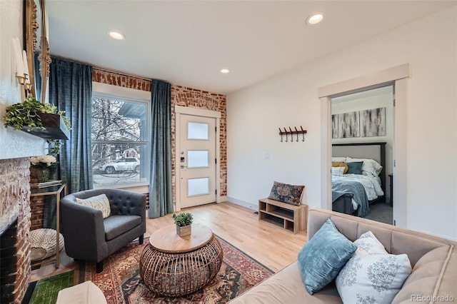 living room featuring recessed lighting, wood finished floors, and a fireplace