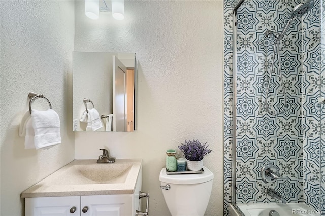 full bathroom featuring vanity, shower / bathing tub combination, toilet, and a textured wall