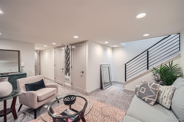 living area with visible vents, baseboards, light colored carpet, stairs, and recessed lighting