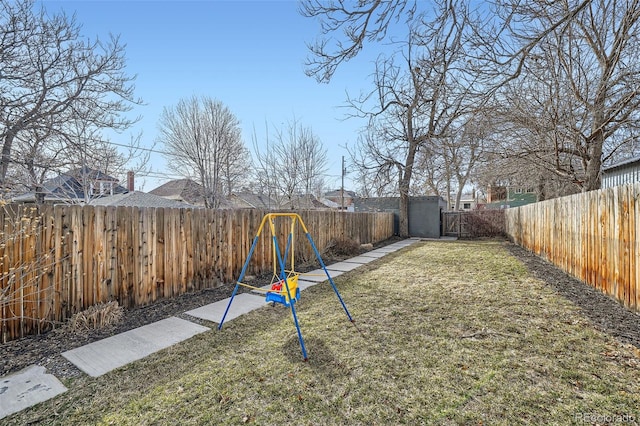 view of yard featuring a playground and a fenced backyard