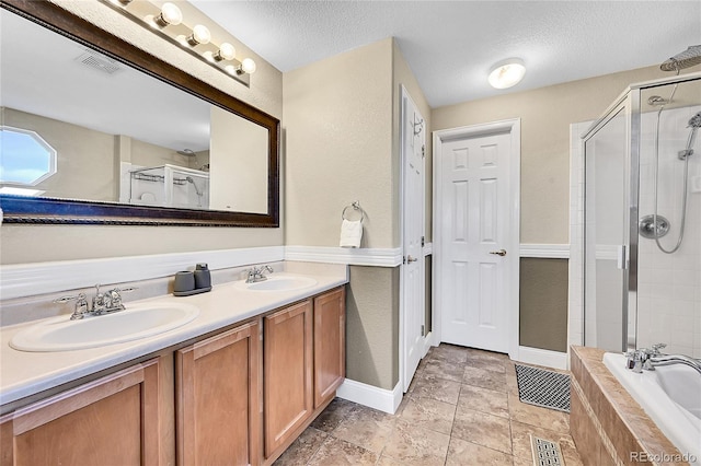 bathroom featuring a stall shower, visible vents, and a sink