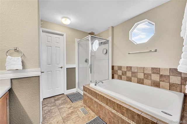 bathroom with visible vents, a shower stall, a bath, and tile patterned floors