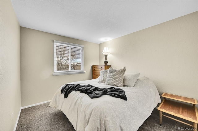 carpeted bedroom featuring a textured ceiling, a textured wall, and baseboards