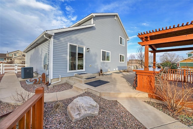 rear view of house featuring a patio, central air condition unit, fence, a gate, and a pergola