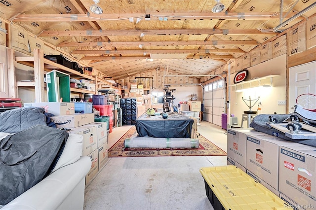 interior space featuring a garage and lofted ceiling