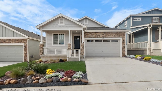 2143 Peralta Loop, Castle Rock, CO 80104 - craftsman house with covered porch, a garage, concrete driveway, and stone siding