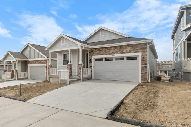 2143 Peralta Loop, Castle Rock, CO 80104 - craftsman-style home featuring a porch, a garage, stone siding, and driveway