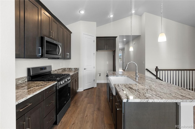 2143 Peralta Loop, Castle Rock, CO 80104 - kitchen with stainless steel appliances, a sink, vaulted ceiling, dark wood finished floors, and a center island with sink