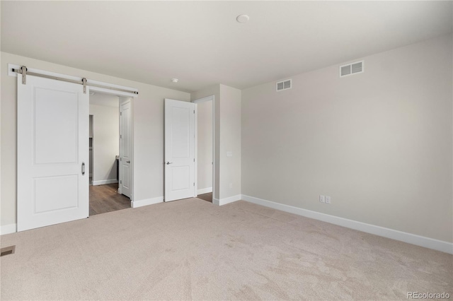 2143 Peralta Loop, Castle Rock, CO 80104 - unfurnished bedroom with carpet, baseboards, and a barn door