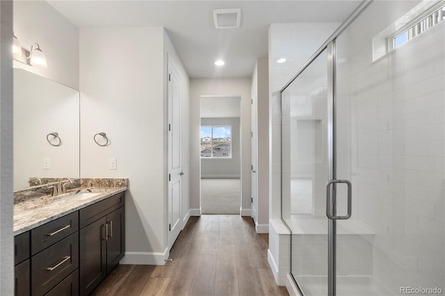 2143 Peralta Loop, Castle Rock, CO 80104 - bathroom with vanity, a shower stall, wood finished floors, baseboards, and recessed lighting