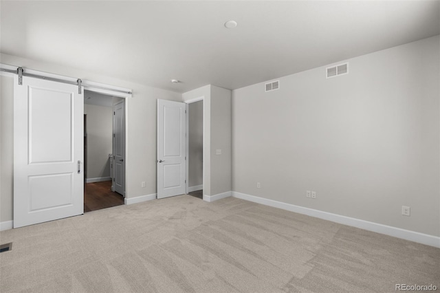 2143 Peralta Loop, Castle Rock, CO 80104 - unfurnished bedroom featuring light colored carpet and a barn door
