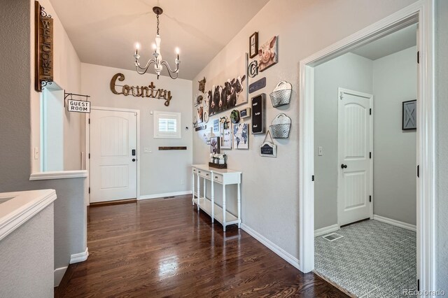 4866 Rainbow Gulch Trl, Colorado Springs, CO 80924 - entrance foyer with a chandelier, dark wood finished floors, and baseboards