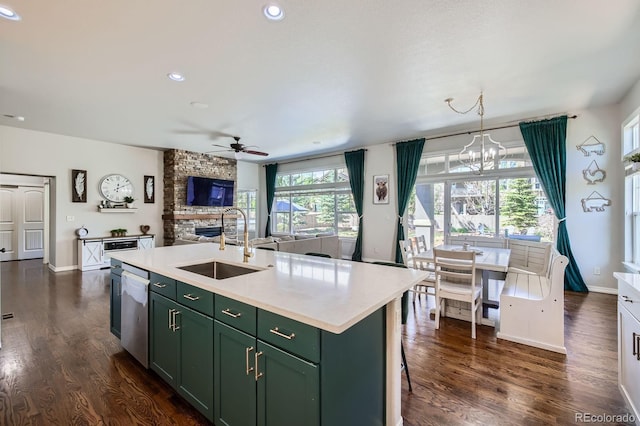 4866 Rainbow Gulch Trl, Colorado Springs, CO 80924 - kitchen featuring green cabinetry, a sink, a stone fireplace, a ceiling fan, and dishwasher