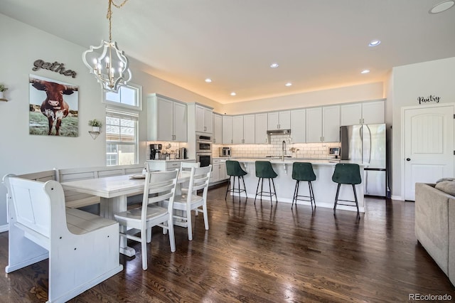 4866 Rainbow Gulch Trl, Colorado Springs, CO 80924 - dining space featuring a chandelier, dark wood finished floors, and recessed lighting