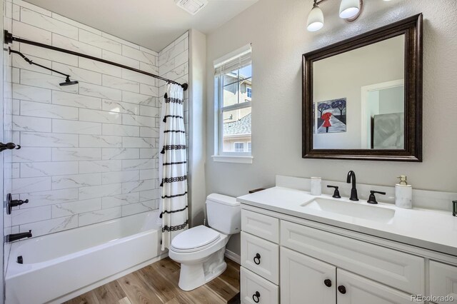 4866 Rainbow Gulch Trl, Colorado Springs, CO 80924 - full bath featuring wood finished floors, shower / bathtub combination with curtain, toilet, and vanity