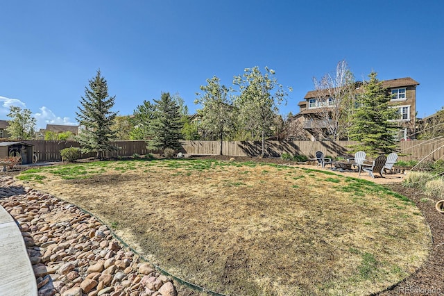 4866 Rainbow Gulch Trl, Colorado Springs, CO 80924 - fenced backyard with an outdoor fire pit