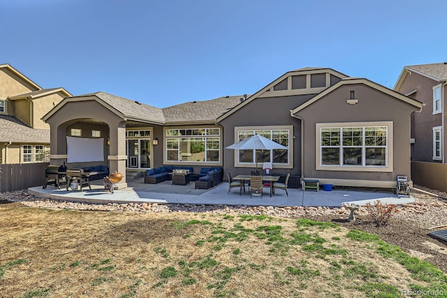 4866 Rainbow Gulch Trl, Colorado Springs, CO 80924 - back of property with outdoor lounge area, a patio, stucco siding, and fence