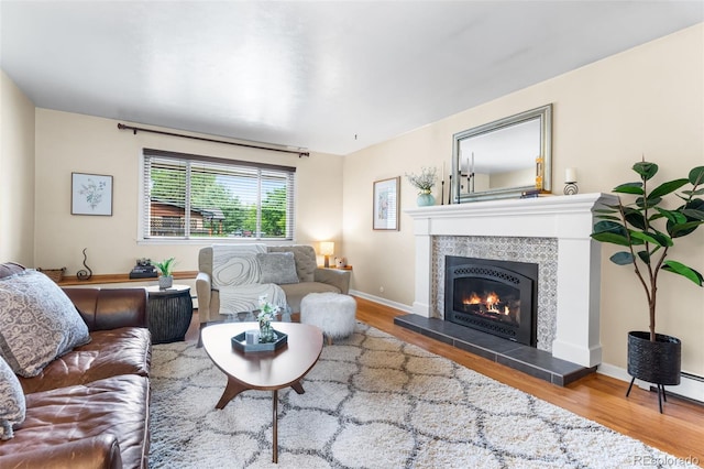 11224 W 28th Pl, Lakewood, CO 80215 - living area with wood finished floors, a fireplace, and baseboards