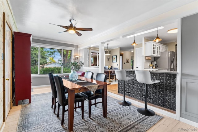 11224 W 28th Pl, Lakewood, CO 80215 - dining space with a ceiling fan, ornamental molding, and light wood finished floors