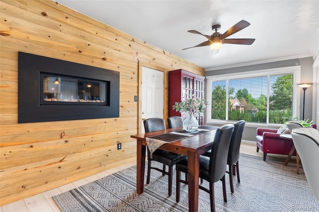 11224 W 28th Pl, Lakewood, CO 80215 - dining area with wooden walls, ceiling fan, and ornamental molding