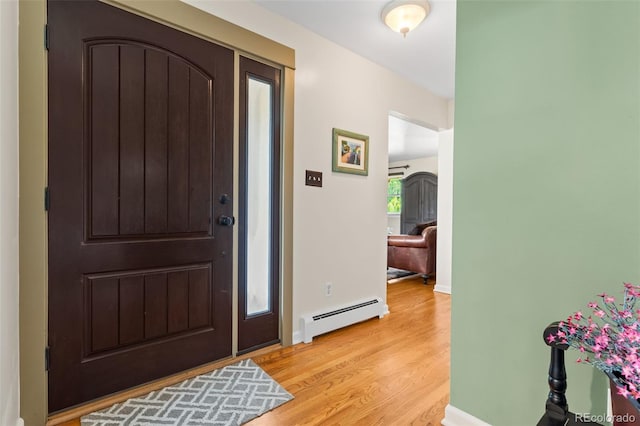 11224 W 28th Pl, Lakewood, CO 80215 - entrance foyer with baseboard heating, light wood-type flooring, and baseboards