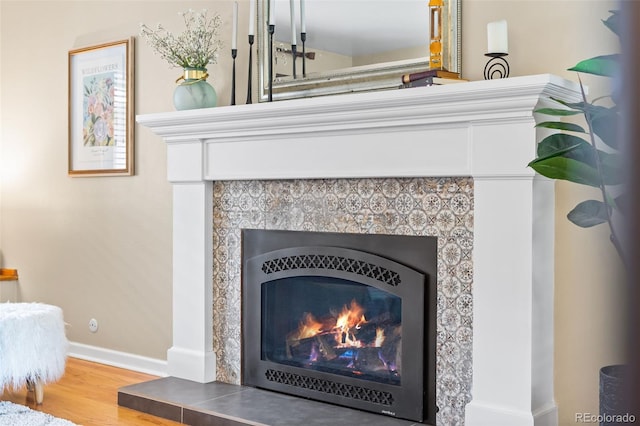 11224 W 28th Pl, Lakewood, CO 80215 - detailed view of baseboards, a tile fireplace, and wood finished floors