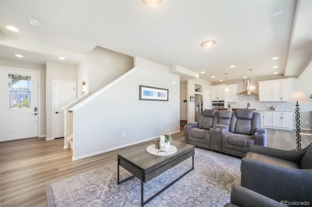 9521 Sideoats Ct, Colorado Springs, CO 80927 - living area with light wood-type flooring, baseboards, recessed lighting, and stairway