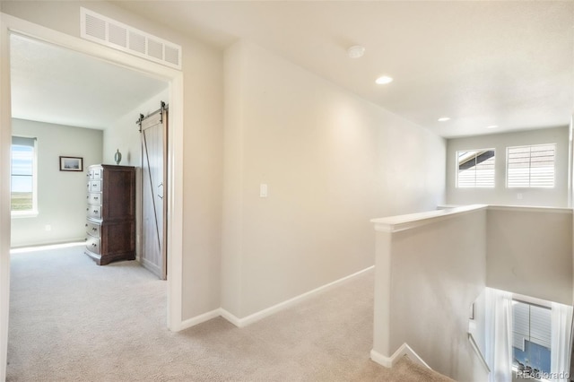 9521 Sideoats Ct, Colorado Springs, CO 80927 - hall with a barn door, light carpet, baseboards, an upstairs landing, and recessed lighting