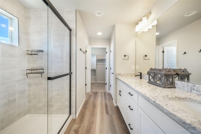 9521 Sideoats Ct, Colorado Springs, CO 80927 - full bathroom with a stall shower, double vanity, recessed lighting, and wood finished floors