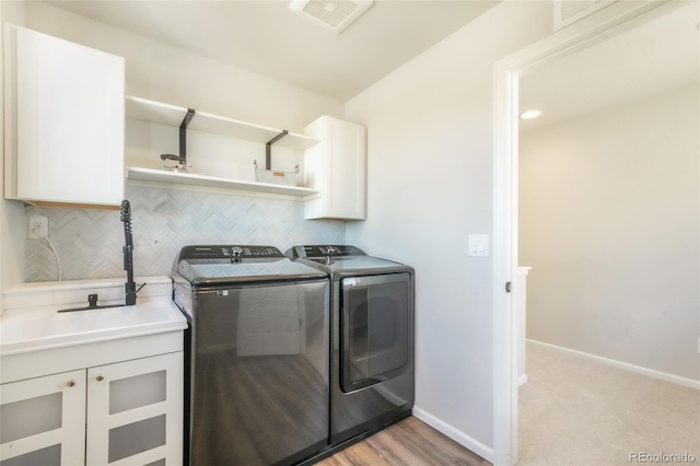 9521 Sideoats Ct, Colorado Springs, CO 80927 - laundry room featuring separate washer and dryer, cabinet space, and baseboards