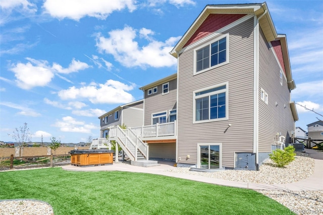 9521 Sideoats Ct, Colorado Springs, CO 80927 - rear view of house featuring a hot tub, a yard, and a deck
