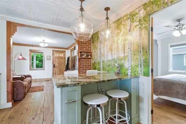 4716 Broadway, Denver, CO 80216 - kitchen with light wood-style flooring, open floor plan, stone countertops, pendant lighting, and ornamental molding