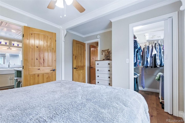 4716 Broadway, Denver, CO 80216 - bedroom featuring dark wood-style floors, a spacious closet, a closet, ornamental molding, and ensuite bath