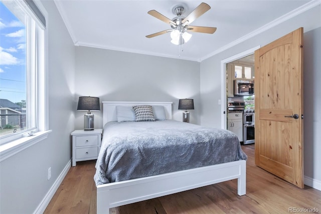 4716 Broadway, Denver, CO 80216 - bedroom with crown molding, multiple windows, wood finished floors, and a ceiling fan