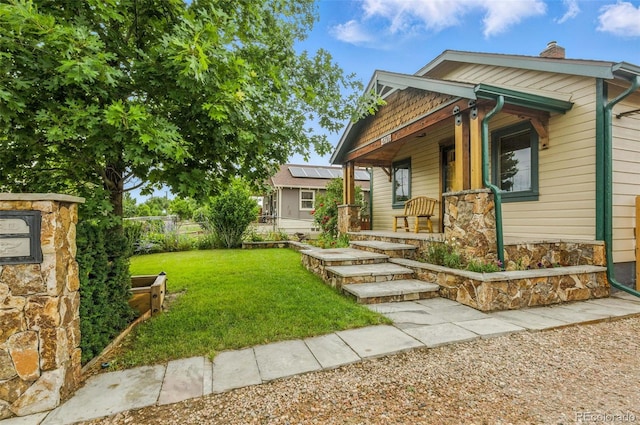 4716 Broadway, Denver, CO 80216 - view of front of property with covered porch, stone siding, and a chimney