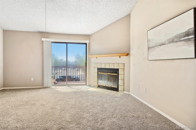 unfurnished living room featuring baseboards, carpet flooring, a tile fireplace, and a textured ceiling