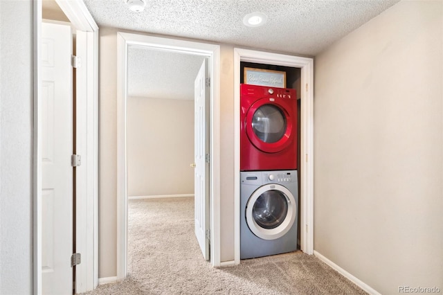 laundry area with carpet flooring, stacked washing maching and dryer, laundry area, and a textured ceiling