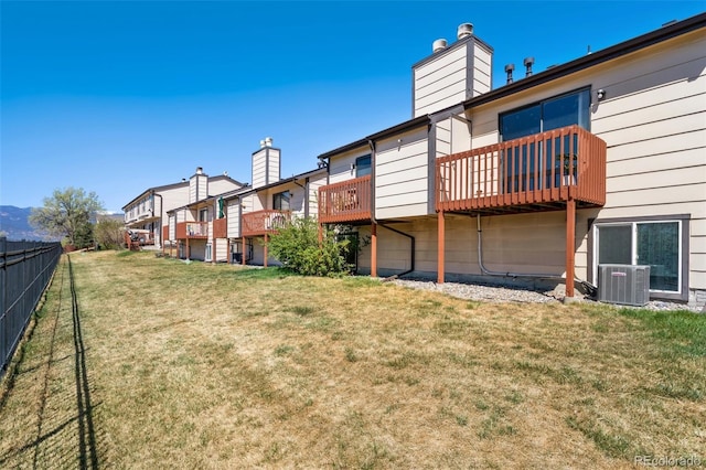 view of yard with a residential view, central AC unit, and fence