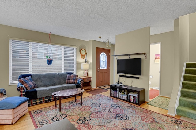 living room featuring light hardwood / wood-style floors and a textured ceiling