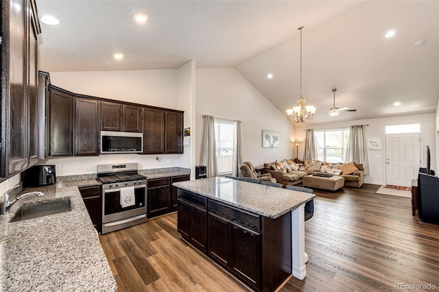 kitchen featuring light stone counters, appliances with stainless steel finishes, sink, and dark brown cabinets