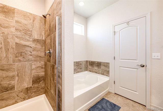 bathroom featuring tile patterned flooring and separate shower and tub