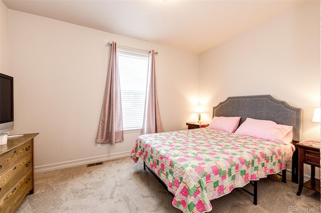 bedroom featuring carpet and multiple windows